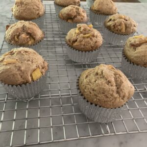 peach muffins on baking rack